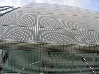 A large piece of Media <d>meta</d>l mesh without LED is installed as the exterior wall cladding of a large building.